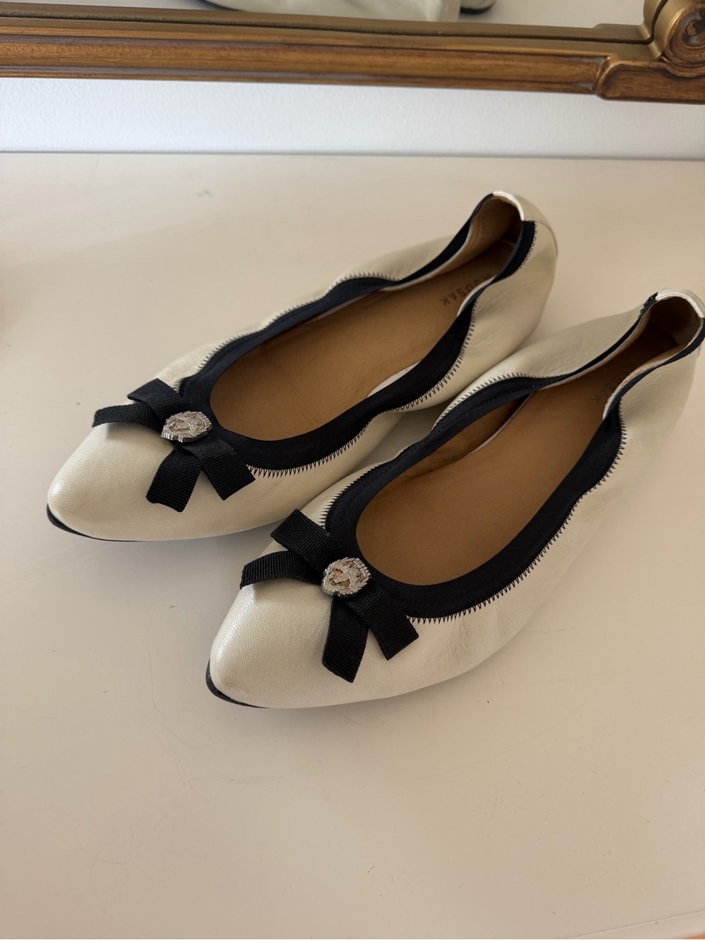 RUDSAK Cream Ballet Flats with Black Trim and Bow Accent
